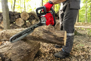 Photo of CRAFTSMAN gas chainsaw CMXGSAMY42N8 cutting a log outdoors, red housing, visible 18-inch bar.