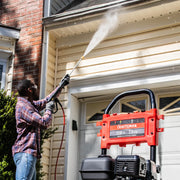 Photo of Craftsman gas pressure washer CMXGWFN061294 in use cleaning house siding, red and black unit visible.