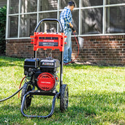Photo of Craftsman pressure washer CMXGWFN061326 on grass, man using it to clean outdoor brick wall in background.