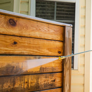 Photo of Craftsman CMXGWFN061326 pressure washer cleaning wood siding near a window.