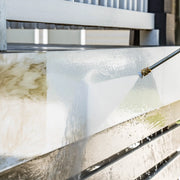 Photo of CRAFTSMAN pressure washer CMXGWFN061369 cleaning a dirty white fence with high-pressure water spray.