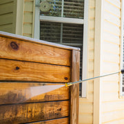 Photo of Craftsman pressure washer cleaning wooden fence, SKU CMXGWFN061369, bright outdoor setting.
