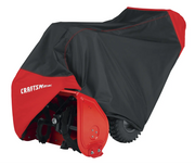 Photo of Craftsman snow blower cover CMXGZAA52001601, black and red, protecting a snow blower, angled view.