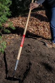Craftsman garden hoe CMXMLTP35319 with wooden handle in use outdoors on soil.