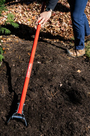 Photo of CRAFTSMAN garden tool CMXMLTP35334 with red handle used for soil preparation outdoors.