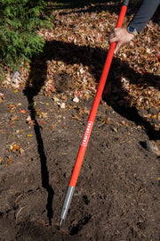 Photo of Craftsman soil probe CMXMLTP35335 with red handle, being used outdoors on soil.