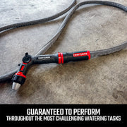 Photo of Craftsman hose nozzle with CMXMWBB16636 model, black and red, attached to flexible hose on concrete floor.