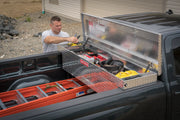 Photo of a Craftsman truck toolbox, SKU CMXTBAK1000901, installed in a black pickup truck with lumber in the bed.