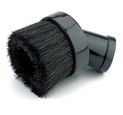 A close-up of a black round vacuum cleaner brush attachment, featuring dense bristles and a shiny plastic connector.