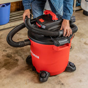 Photo of Craftsman wet/dry vacuum CMXZVBE38660, red body, black hose, in garage setting.
