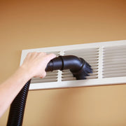 Photo of CRAFTSMAN CMXZVBE38725 vacuum brush cleaning a white vent against a beige wall.