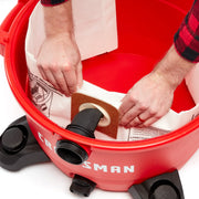 Photo of Craftsman CMXZVBE38735 vacuum with hands installing dust collection bag inside red canister.