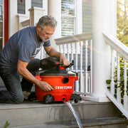Photo of Craftsman wet/dry vacuum, SKU CMXZVBE38778, draining water on porch steps during outdoor use.