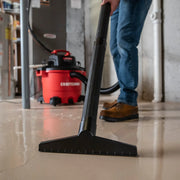 Photo of Craftsman wet/dry vacuum CMXZVBE38778 being used on a wet basement floor, close-up of large nozzle.