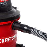 Photo of Craftsman wet/dry vacuum CMXZVBE38804 close-up, showing hose connection and red canister, angled on white background.