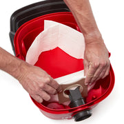Photo of hands installing a vacuum bag inside a red CRAFTSMAN vacuum canister, SKU CMXZVBE43271, top view.